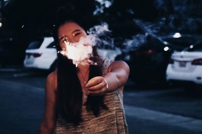 Young woman smoking cigarette