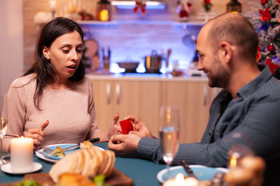 Portrait of young woman using mobile phone at restaurant