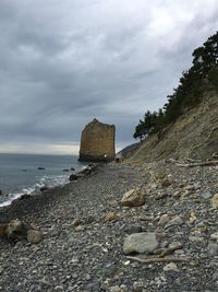 Rock formations by sea against sky