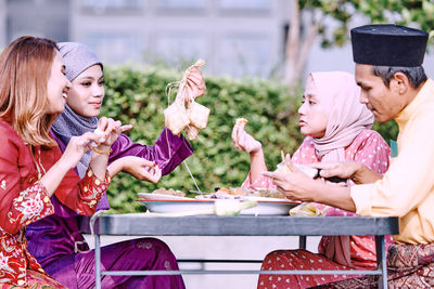 Friends and family enjoying festival meal during the eid celebration