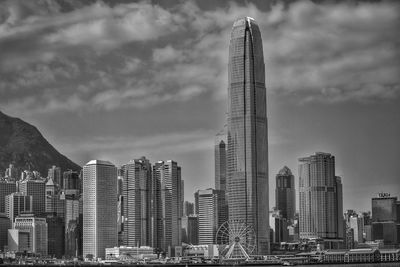 Low angle view of buildings against cloudy sky in hong kong 