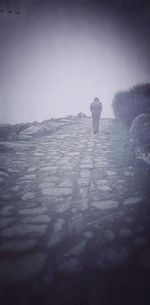 Full length of woman standing on railing