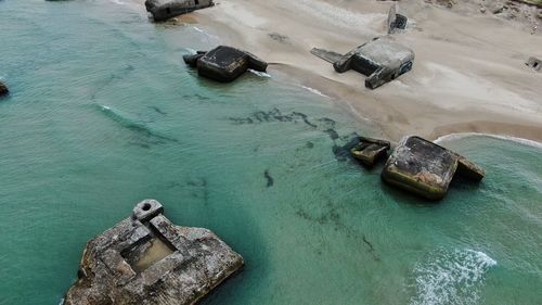 High angle view of rocks on sea shore