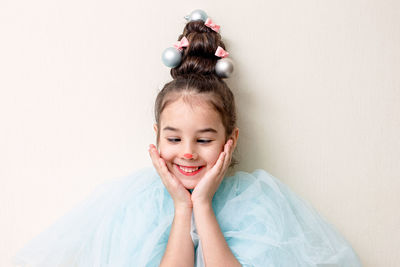 Cheerful portrait of a little girl with styling in the form of a christmas tree