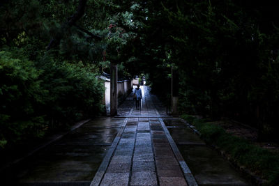 Woman walking on footpath