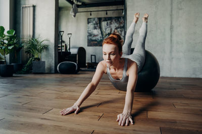 Full length of senior woman sitting on floor