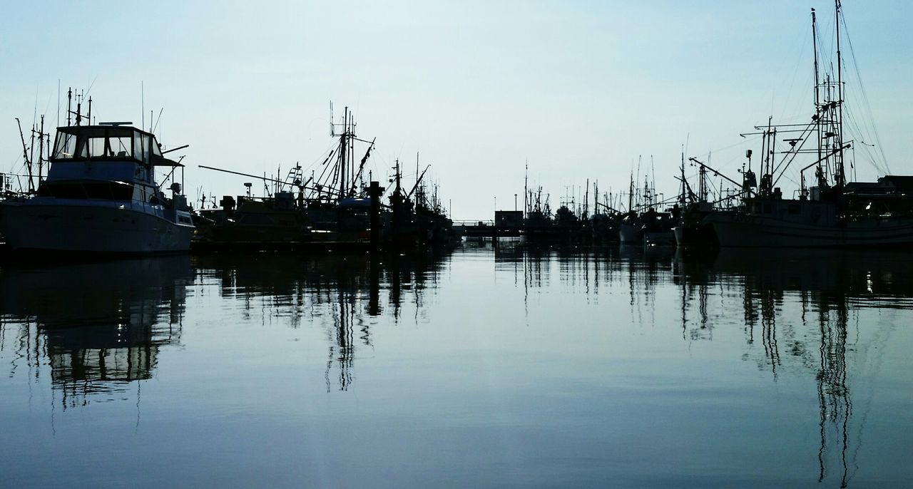 water, nautical vessel, moored, transportation, harbor, mode of transport, boat, clear sky, reflection, waterfront, mast, lake, sky, commercial dock, copy space, sailboat, sea, no people, outdoors, nature