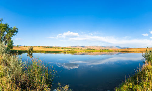 Scenic view of lake against blue sky