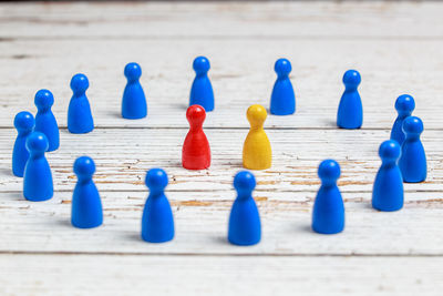 Multi colored tokens arranging on wooden table