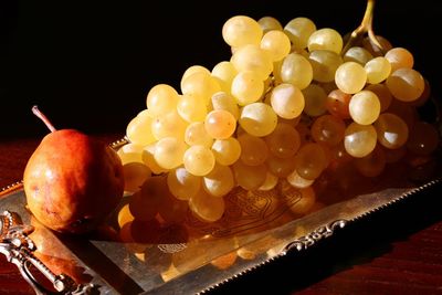 Close-up of apples on table against black background