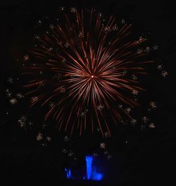 Low angle view of firework display at night