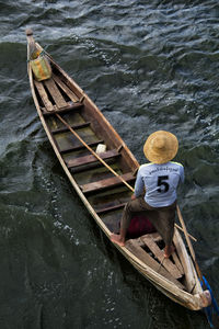 High angle view of man sitting in river