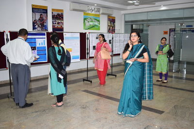 Woman wearing sari while standing in college corridor