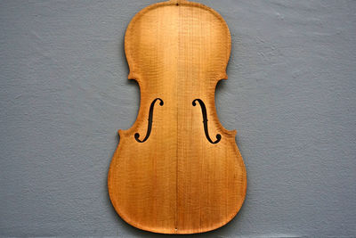 Directly above shot of incomplete wooden violin
