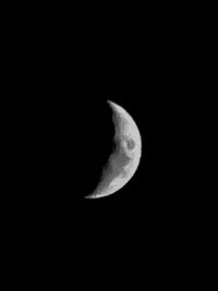 Low angle view of half moon against sky at night