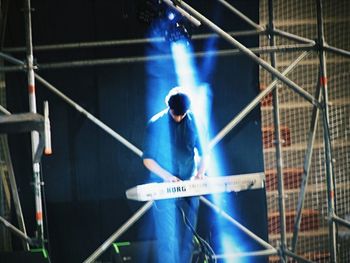 Man standing in illuminated building