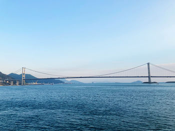 View of suspension bridge over sea