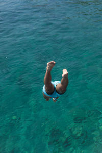 Low section of man diving into sea