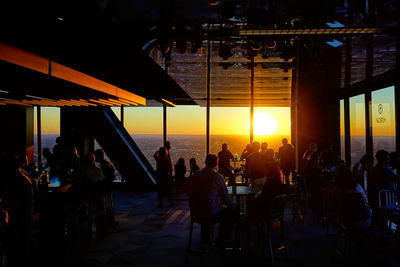 Group of people in restaurant at sunset