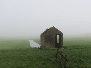 Built structure on field against sky