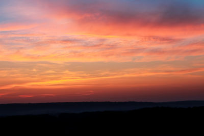 Scenic view of silhouette landscape against romantic sky at sunset