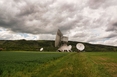 Built structure on field against sky