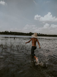 Man standing on beach against sky