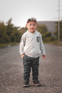 Portrait of boy standing on road