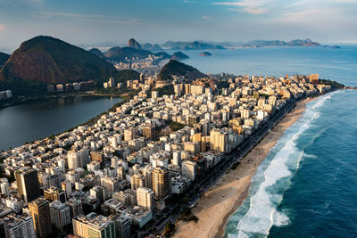 Panoramic view of sea and buildings against sky