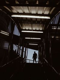 Silhouette man walking on staircase