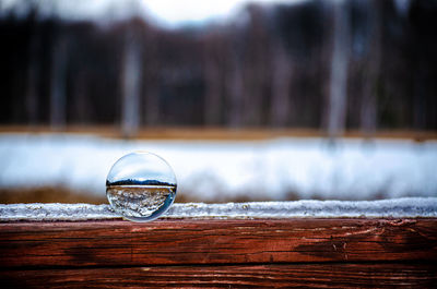 Close-up of crystal ball on wooden table