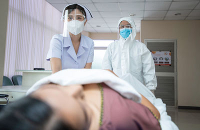 Midsection of woman standing in front of people