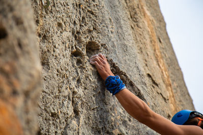 Close-up of shirtless man rock climbing 