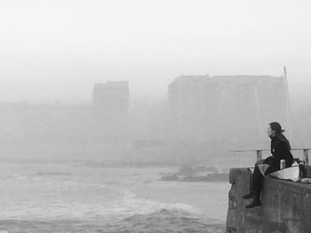 People standing in foggy weather