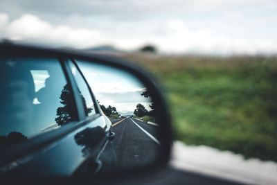 Reflection of car on side-view mirror