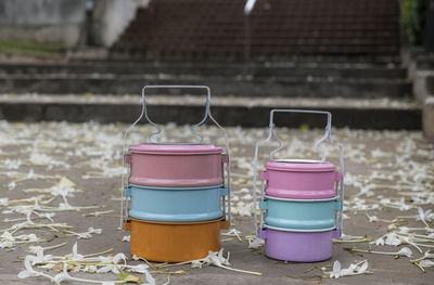 Colorfull enamelled tiffin food on floor have flower metal box lunch picnic, thai food carrier style