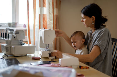 Side view of businesswoman working at office