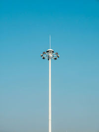 Low angle view of floodlight against clear blue sky