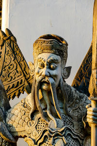 Low angle view of statue against temple building