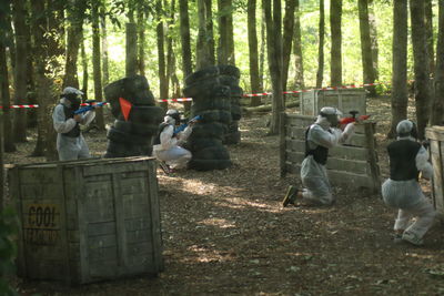 Rear view of people walking in forest