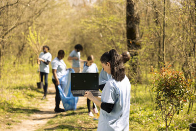 Rear view of woman using mobile phone