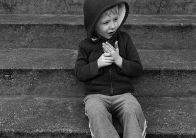 Close-up of boy sitting on steps