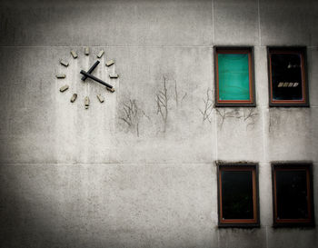 Low angle view of clock on wall