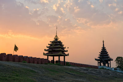 Gazebo in building against sky during sunset