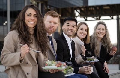 Portrait of smiling friends standing in restaurant