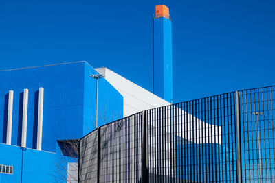 Low angle view of building against clear blue sky