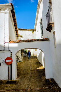 Rear view of woman walking on building