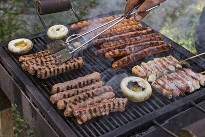 Preparing barbecue meat at picnic in nature. the meat is roasted in a conventional way.