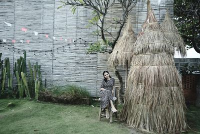 Woman standing by tree trunk