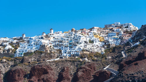 Panoramic view of trees and mountains against clear blue sky